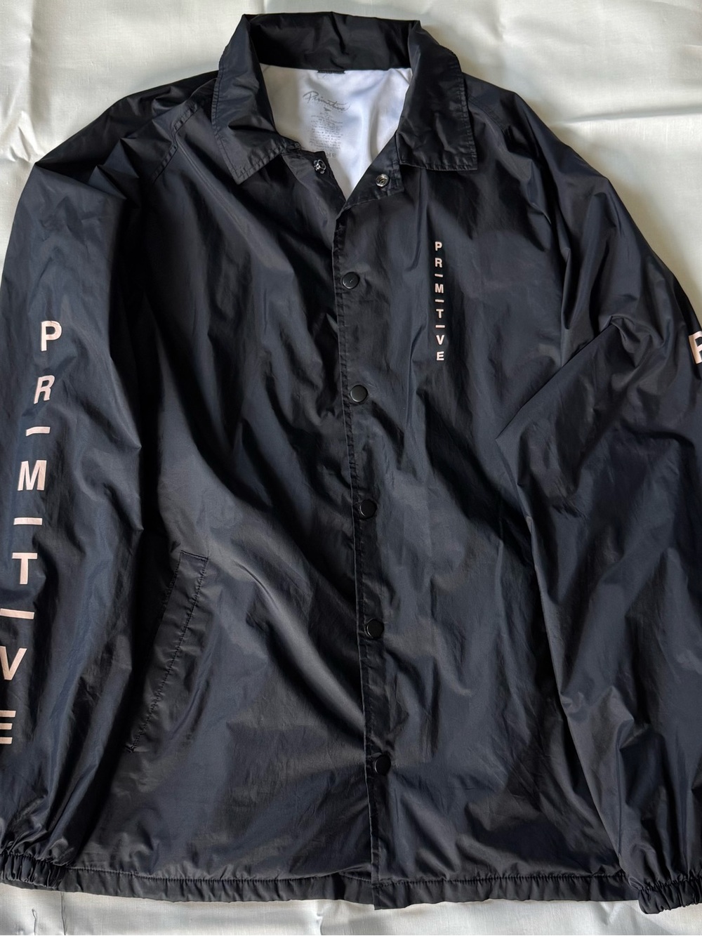 Primitive Black Windbreaker Jacket with Pink Logo Accents